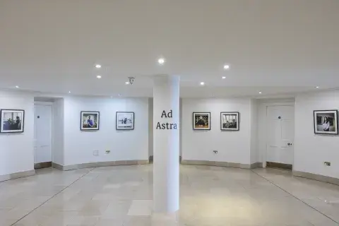 A white gallery featuring 6 photos on the wall