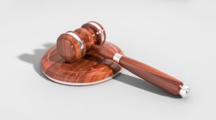 A gavel resting on a sound block