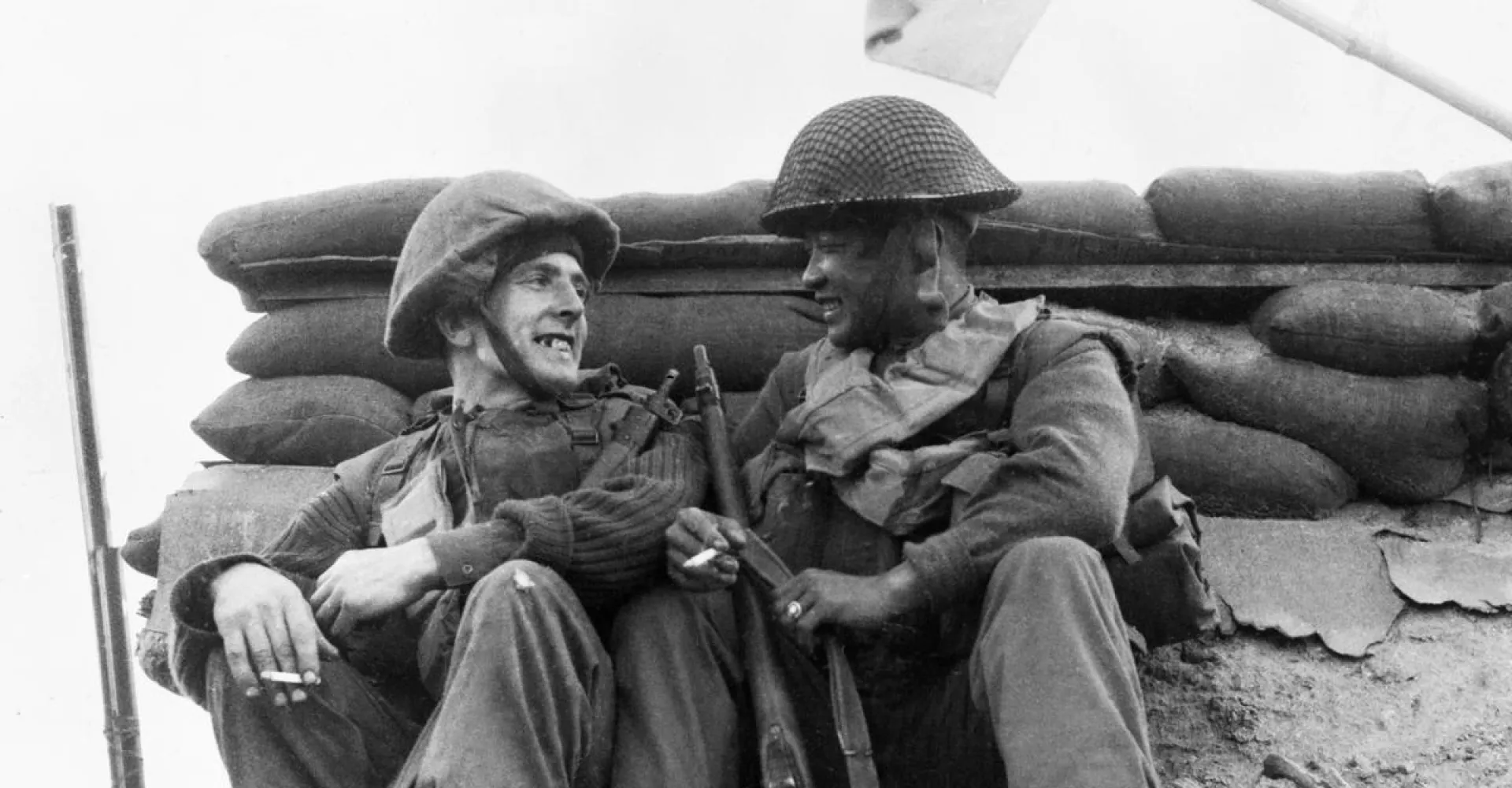 Two men of the 1st Battalion, The Black Watch rest and smoke before moving off on patrol after heavy fighting on the previous night