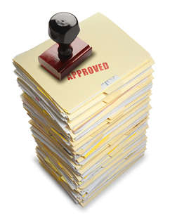 A pile of papers stamped 'approved'.
