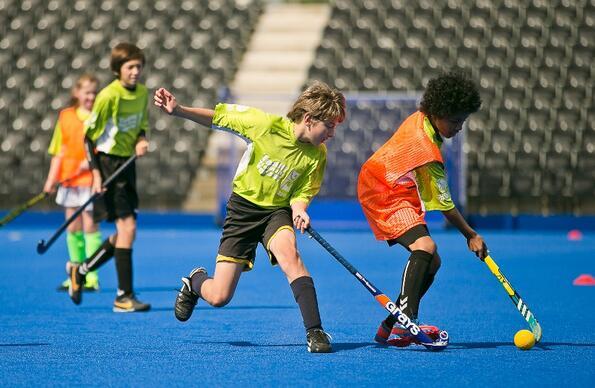 Children playing in a hockey match at the centre