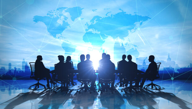 Picture of meeting with world map in background