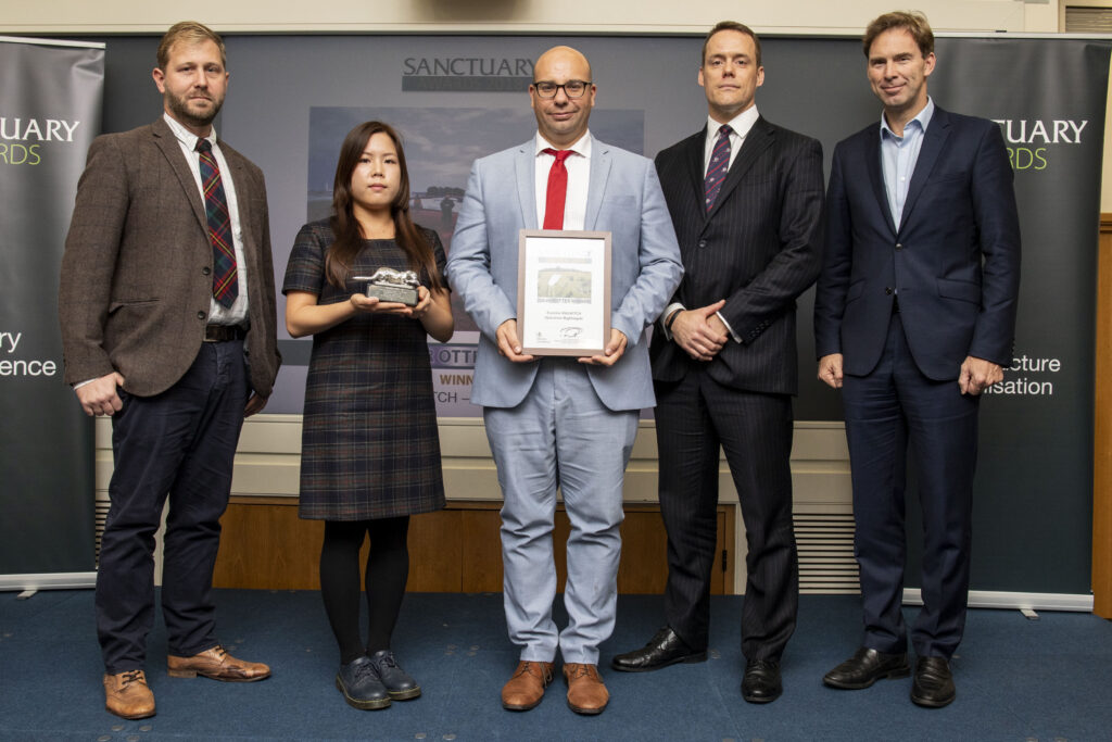 Representatives of Exercise MAGWITCH pose with their Silver Otter award and Minister of Defence Personnel and Veterans, Tobias Ellwood MP.