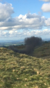 Smoke rises from the destroyed shell.