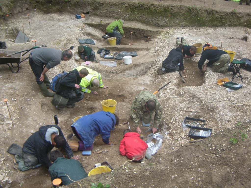 Pictured are 13 people including veterans from Operation Nightingale who were injured in war working on an excavation dig at Salisbury Plain.