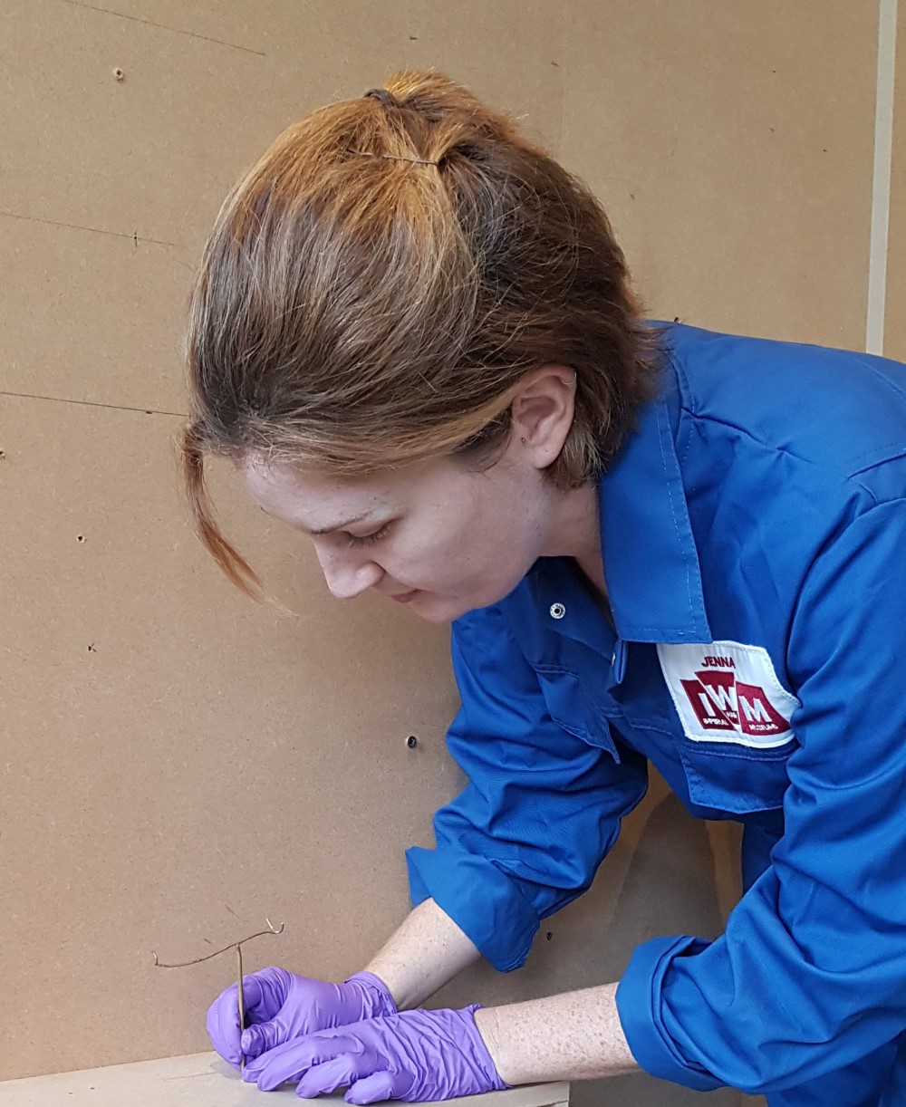 Senior Conservator, Jenna Taylor, places a mount in position (Copyright IWM)