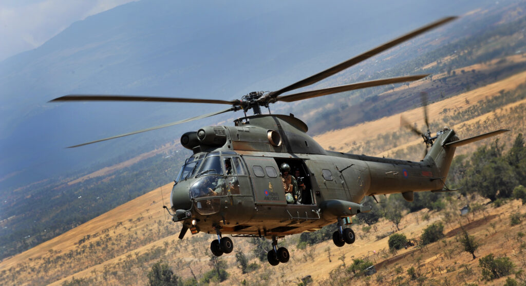 A Puma helicopter from the Royal Air Force flies over the plains of Kenya.