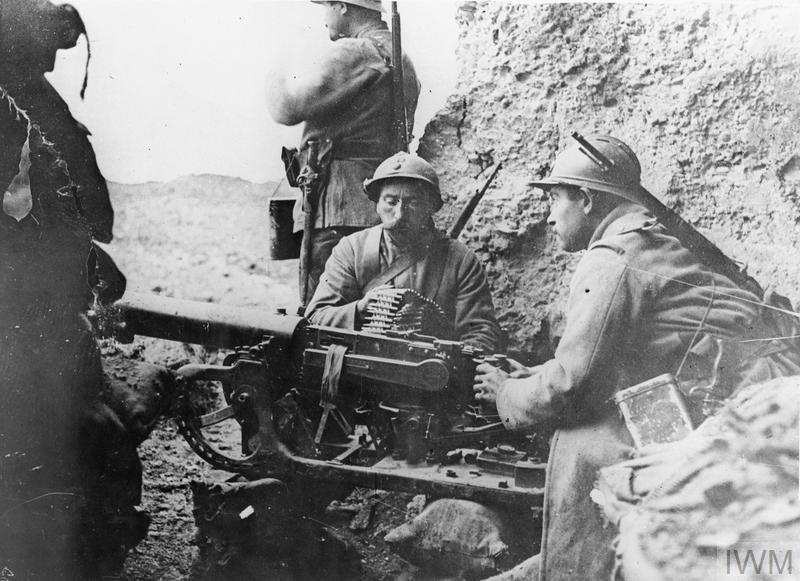 French troops manning a captured German Maxim MG 08 machine gun (mounted on a sledge) at Fort Douaumont, Verdun.