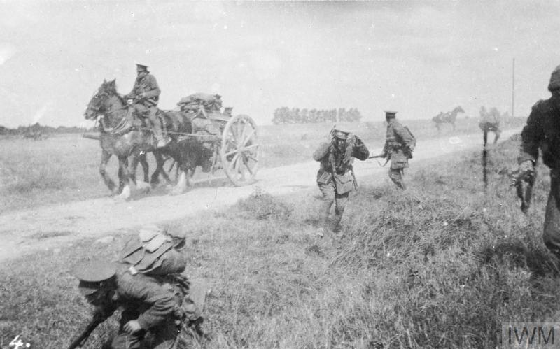 Troops of the 1st Battalion, Middlesex Regiment under German shrapnel fire. One man is badly wounded in the head has blood on his face. 
