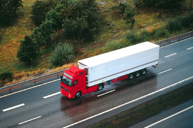 a red lorry driving along the motorway