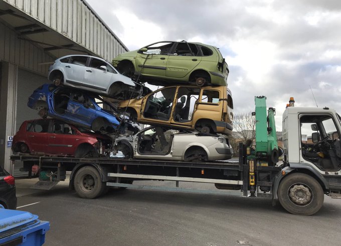 Towering overload lorry with cars due for scrappage