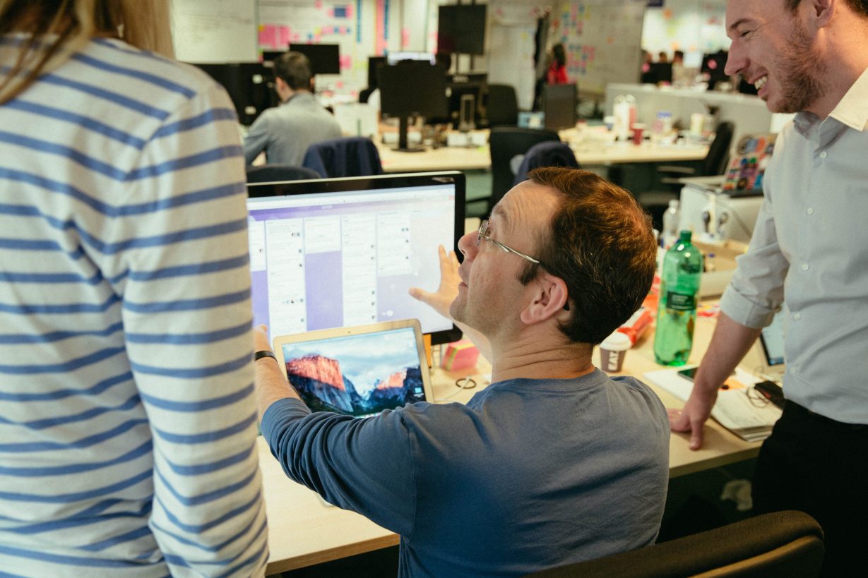 Members of the People Board having a chat at a computer