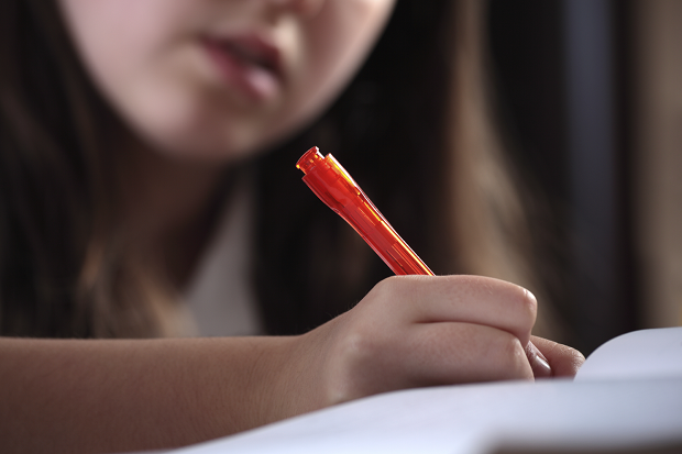 Girl holding pen