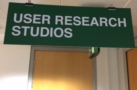 Door with a sign that reads "User Research Studios"