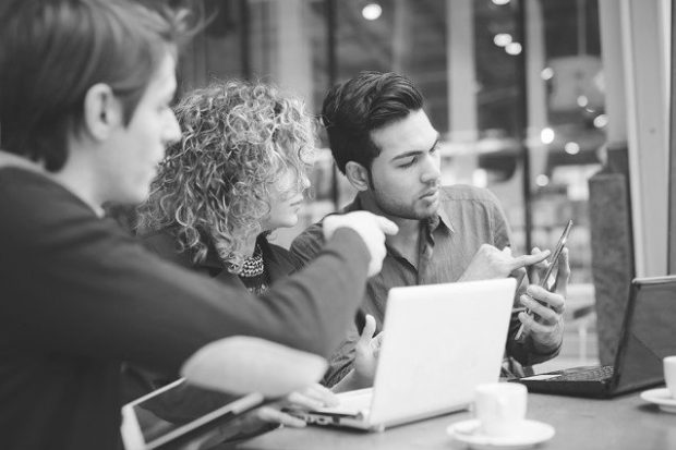 Three colleagues having a discussion and looking at computer screen