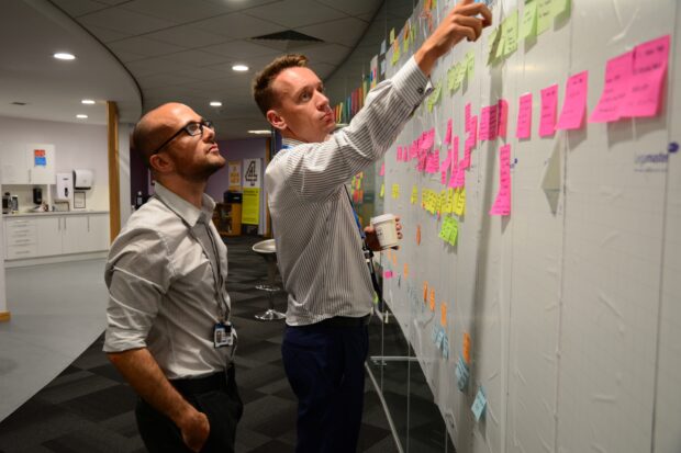 Product Manager, Andy, and another colleague having a meeting