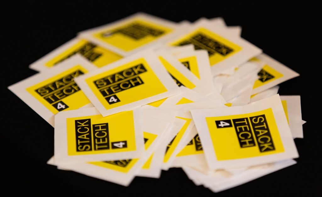 A pile of StackTech4 stickers