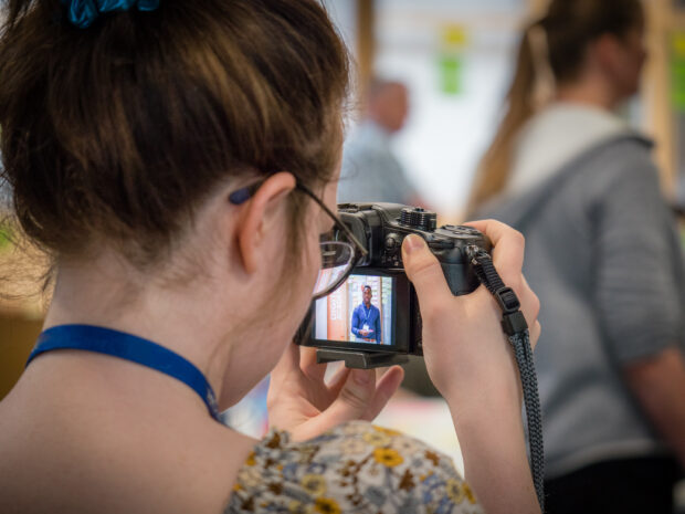 Catherine taking photos during a show and tell