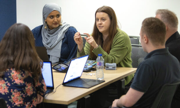A group of colleagues sitting around a table, having a meeting