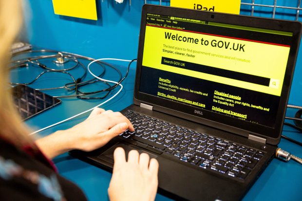 GOV.UK homepage on a laptop in the GDS Accessibility Empathy Lab in high contrast yellow and black.