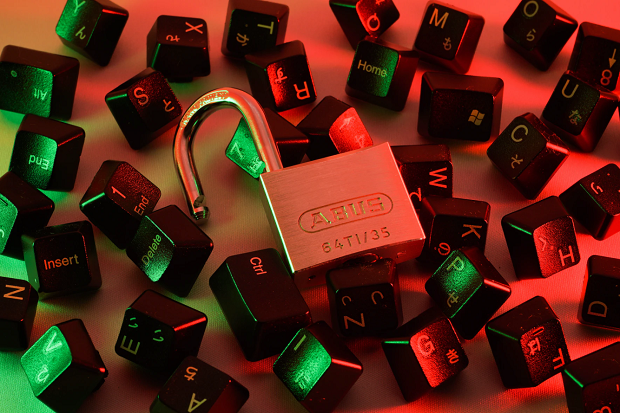 A padlock on top of a pile of keyboard keys