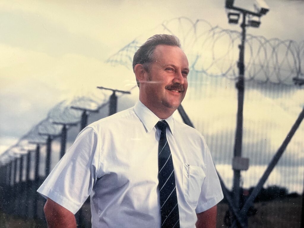 An old photograph of Tom Meadows in uniform while working on site for the Security Services Group