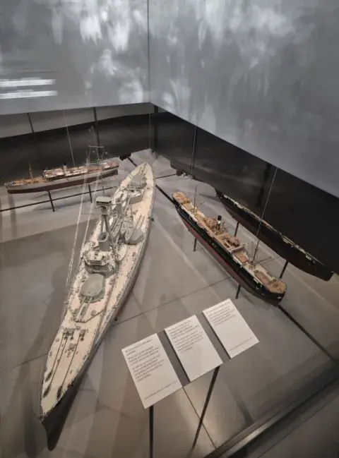 The model of HMS Hercules (centre) on display at IWM London. 
