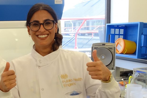 The Image shows a women in a science lab