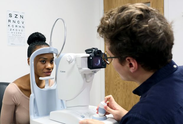 Woman having photos of her retina taken with a digital screening camera