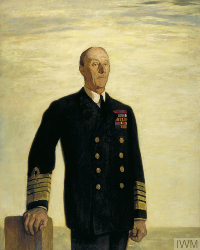 A three quarter-length portrait of Jellicoe in uniform. He stands with the sea, horizon and a golden sky behind resting one hand on a post.