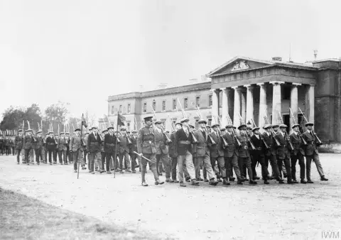 Officer Cadets of the Junion Division (still in civilian cloths) marching past the Old College at the Royal Military Academy Sandhurst, November 1917.
