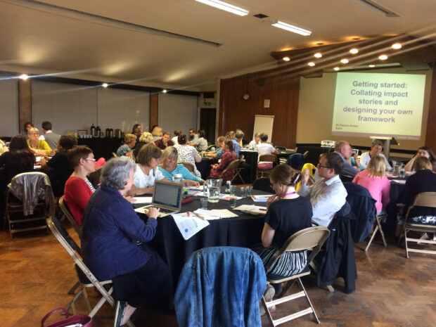 Attendees at a workshop sitting around tables