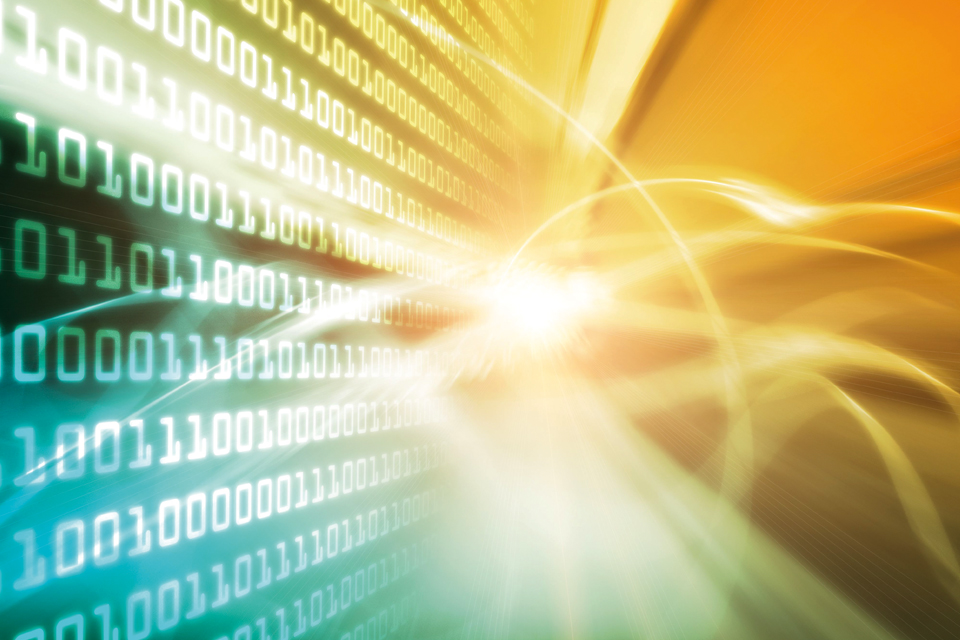 Binary code on a laptop with blurred yellow lighting