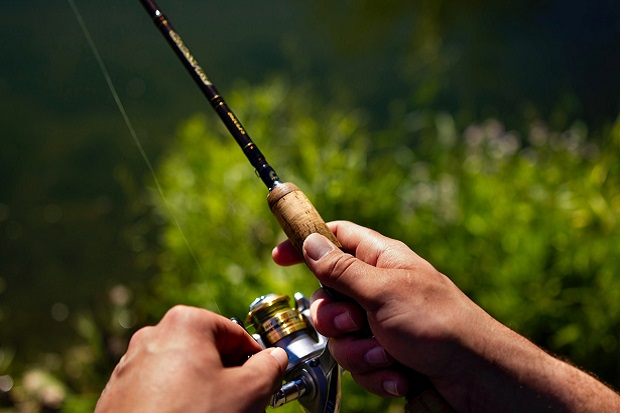 A person holding a carp.