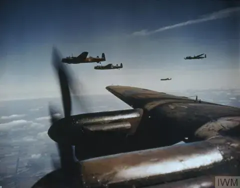 A group of Lancaster bombers flying in blues skies