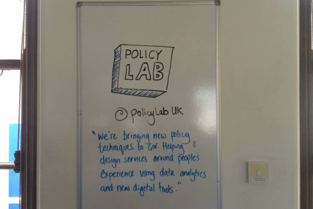 Picture of Policy Lab logo on a whiteboard with 'mission' text beneath