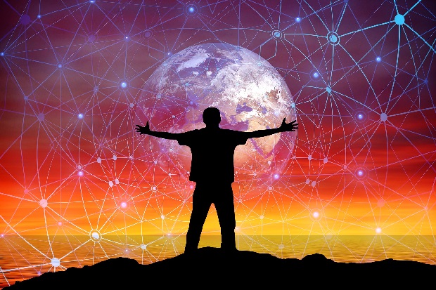Man on mountain embracing world enveloped in digital net of creativity