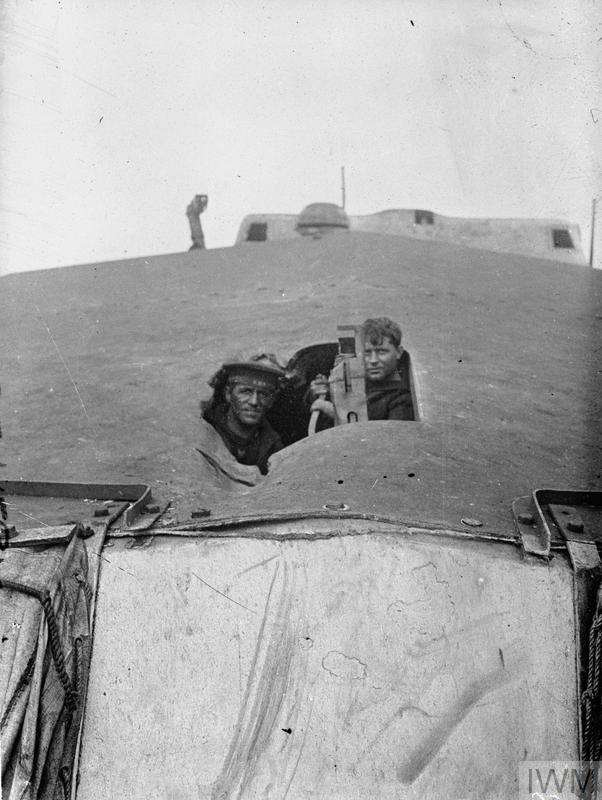 Two sailors looking through a shell hole in the forward turret roof of the battlecruiser HMS TIGER. Overall she was hit fifteen times by large calibre shells during the battle of Jutland and lost twenty four members of her crew killed and a further forty six wounded.