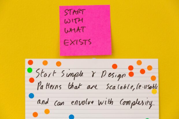 A Post-it on a wall reading 'start with what exists'