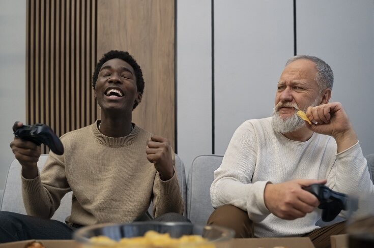 Young man and older an playing video games