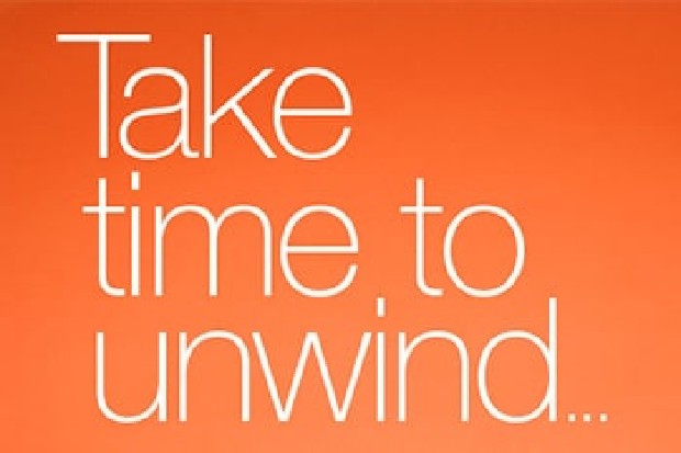 orange rectangle with white words that say take time to unwind