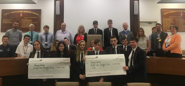 The Young Carers with their Civil Service Mentors at Atherstone Town Hall receiving their certificates from the Mayor. They are holding two huge cheques, being the amount they raised in the course of their project with North Warwickshire Aspire.