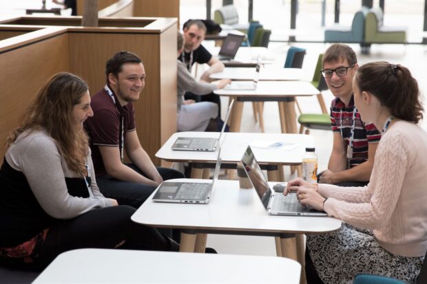 UKHO employees with their laptops in an informal 'coffee and code' meeting
