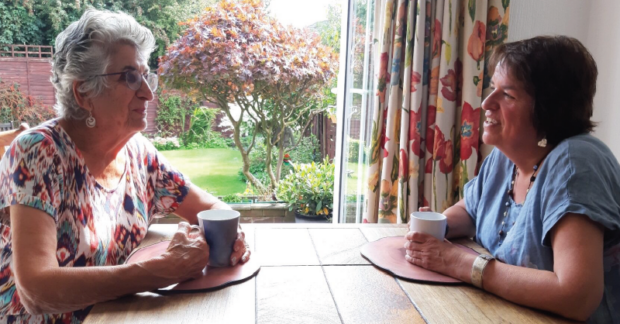 Maureen (left) and Petra (right) sat at a table with a cup of tea each. 