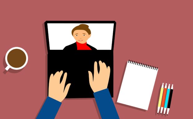 Person watching a webinar on a laptop.