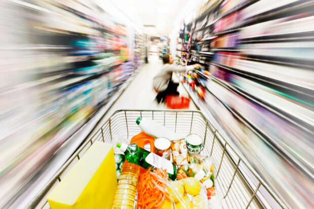 A shopping trolley in a supermarket aisle.