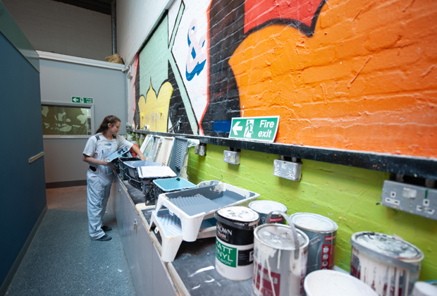 Apprentice preparing paint in training school