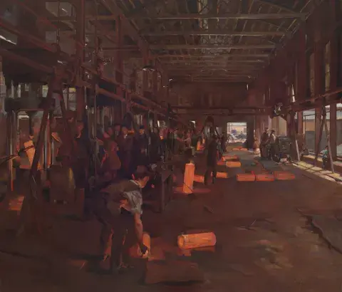 Interior of a factory - workers stand at their stations. Shells in production are visible. 