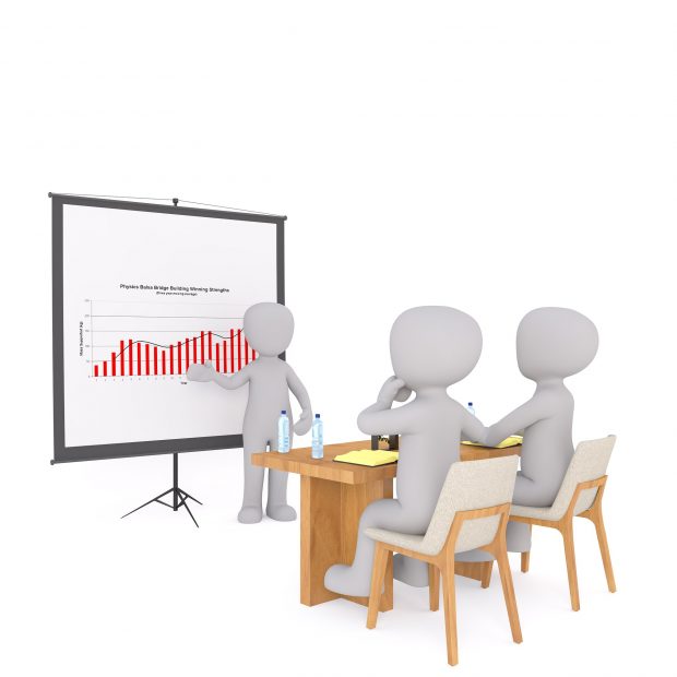 A discussion between 3 individuals. One is presenting data to the other 2.