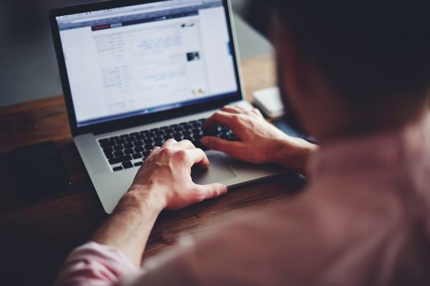Man using a laptop on a desk
